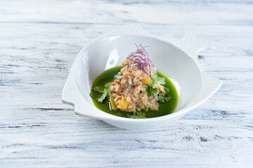fish tartare with oranges and onions with green sauce