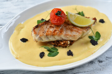 grilled fish fillet with vegetable puree, tomatoes and lemon