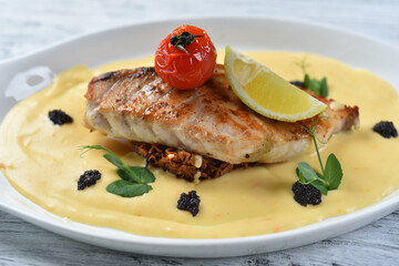 grilled fish fillet with vegetable puree, tomatoes and lemon