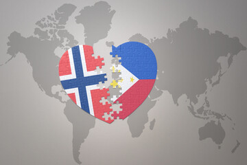 puzzle heart with the national flag of norway and philippines on a world map background. Concept.