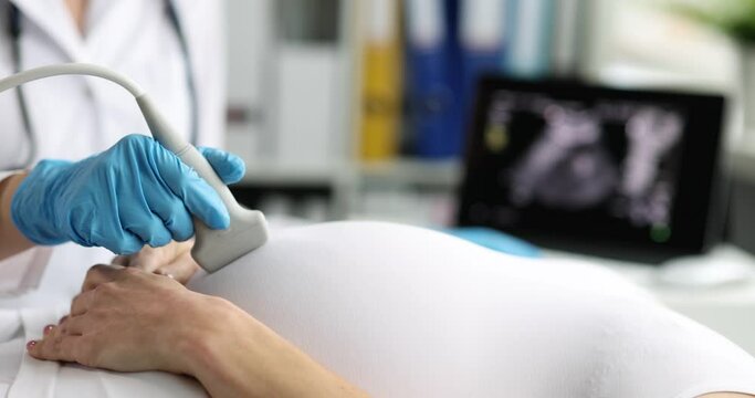 Pregnant woman undergoes ultrasound in clinic closeup