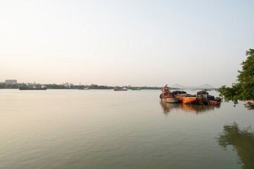 Fototapeta na wymiar Beautiful Howrah bridge on the river Hooghly or River Ganges during sunset. 