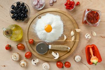 Ingredients for cooking italian pizza on a wooden table, top view. Italian traditional cooking