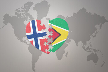 Naklejka premium puzzle heart with the national flag of norway and guyana on a world map background. Concept.