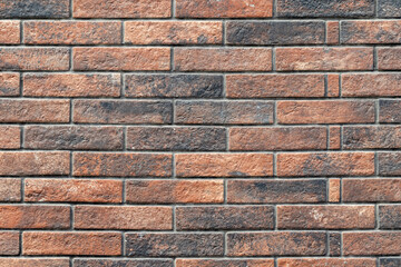 Brick wall background of red and black bricks neatly arranged.