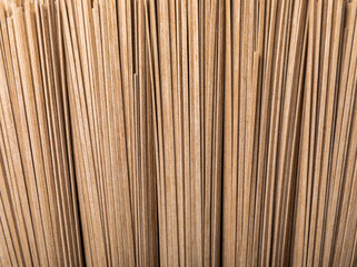 Buckwheat paste on a black cement background. Raw noodles. Ingredients for a gluten-free dish. Dried buckwheat soba noodles. Traditional Japanese food. Healthy food. Place to copy.