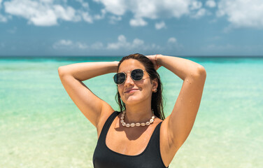 portrait of young hispanic woman with sunglasses in mexican caribbean