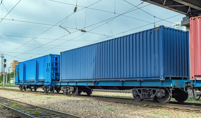 Fototapeta na wymiar Flatcars (flat wagons) with 40ft containers on Trans-Siberian Railroad. Fitting platforms.