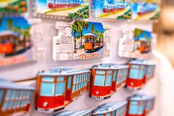 Mallorca, Spain. April 27, 2022. Close-up of fridge magnets arranged on wall. Soller tram souvenirs...