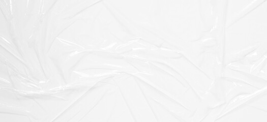 Transparent plastic wrap on white color background. Crumpled wrinkled plastic cellophane....