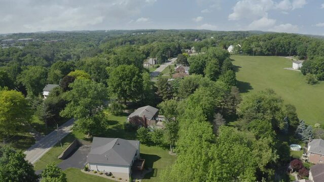 An aerial summer establishing shot of a typical upscale Pennsylvania residential neighborhood. Pittsburgh suburbs. Alternate angles available.  	