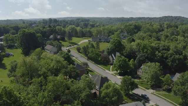 A slow forward moving aerial summer establishing shot of a typical rural Pennsylvania residential neighborhood. Pittsburgh suburbs. Alternate angles available.  	