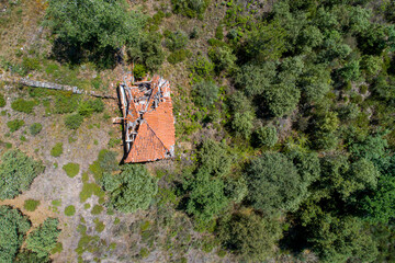 Overhead drone aerial view of an abandoned house in ruins