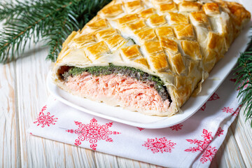 Homemade Salmon Wellington. It is made from Salmon Fish, spinach, mushrooms, spices, herbs and puff pastry. Copy space.