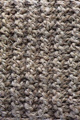 Brown texture of a loofah for washing a body close-up. Texture of a jute wash cloth macro photography.