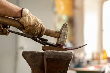 Close up view of heated metal and anvil. The blacksmith in the production process of metal products...