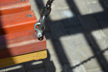 swing on chains in the city park. children's playground