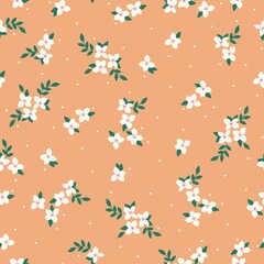 Simple vintage pattern. Small white flowers and dots, green leaves. Orange background. Fashionable print for textiles and wallpaper.