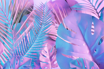 Tropical background with leaves in vibrant gradient holographic neon colors. Creative summer...