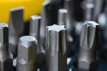 Set of bits for screwdriver. Metal bits for screwdriver. Tool set for household use. Nozzles and adapters for screwdrivers. Head different size hex driver. Selective focus