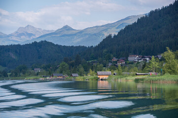 Weissensee lake in an early morning and a village