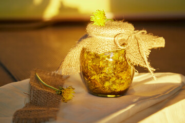 Homemade herbal organic dandelion tincture with wild flowers. Dandelion root tincture...