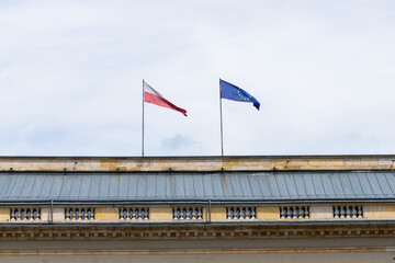 Polish and European Union flags hung on the building