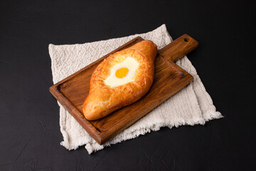 Khachapuri, khachapuri on a black background, Georgian cuisine