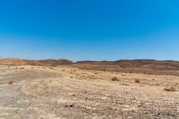 Fototapeta na wymiar A view from the crater in the Ramon Crater. Arid desert view. White sands and a horizon of blue skies. Negev, Israel. High quality photo