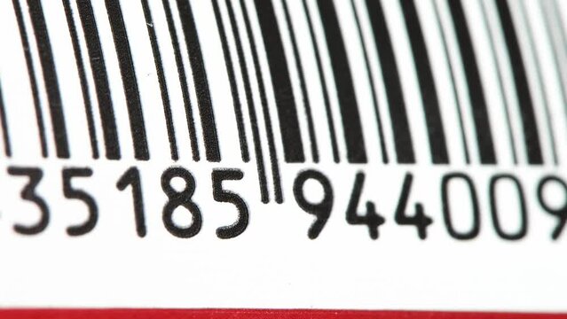 Part of a barcode on a simple drink tin can, bar code tag label object rolling in, detail, macro extreme closeup, nobody. Food products origin, retail business and consumerism abstract concept