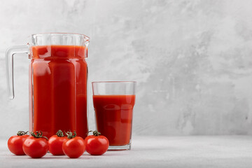 tomato juice in jug and tomatoes