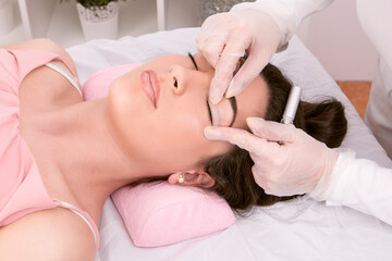 Beautician preparing the eyelid for the eyelash lifting procedure. High quality photo