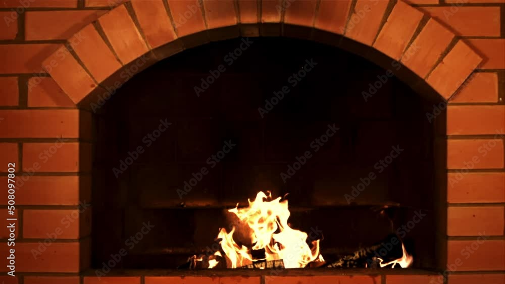 Canvas Prints Wood burns in the fireplace. Against a dark background. Filmed is slow motion 1000 fps.