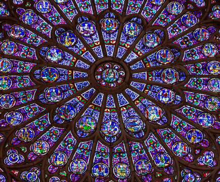 Paris, France, March 27, 2017: Stained glass window at Notre Dame cathedral. Notre Dame church is one of the top tourist attractions in Paris. Inside the old Gothic landmark of Paris