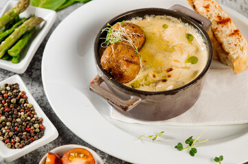 Potatoe puree dish with herbs on concrete background