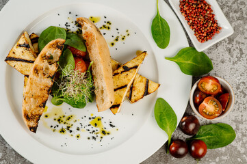 Grilled cheese tofu with toasted bread and vegetables