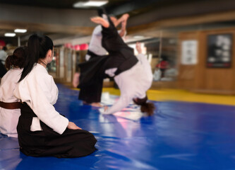 Aikidoka uses the technique joint lockon the opponent during the training of aikido, close up