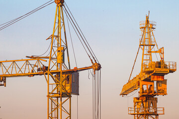 Tower cranes with hydraulic boom lift. Tower cranes on the construction of a new residential building.