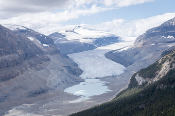 Massive melting glacier with glacial pool on its bottom, horizontal shot, Jasper, Canada