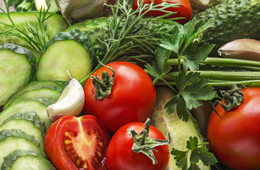 Background from vegetables. Fresh organic vegetables tomatoes, onions, cucumbers and greens.
