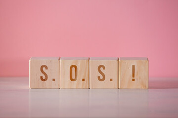 Square woods chips writing "S.O.S!"