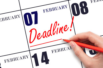 Hand drawing red line and writing the text Deadline on calendar date February 7. Deadline word...