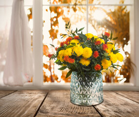 Bouquet of beautiful flowers in glass vase on wooden table, space for text