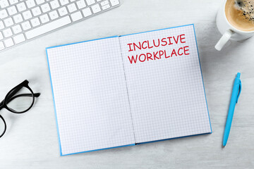 Inclusive workplace. Notebook, keyboard and coffee on white wooden table, flat lay