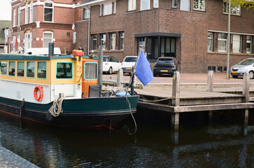 Beautiful city canal with moored boat at pier