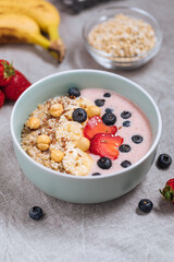 Healthy oatmeal with yoghurt, blueberries, strawberries, banana and seeds. Healthy fitness meal, superfood. 