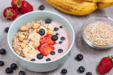 Healthy oatmeal with yoghurt, blueberries, strawberries, banana and seeds. Healthy fitness meal, superfood. 