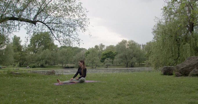Young sportswoman doing yoga in the park.