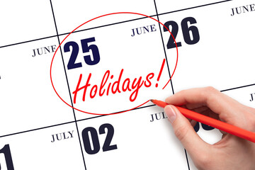 Hand drawing a red circle and writing the text Holidays on the calendar date 25 June. Important...