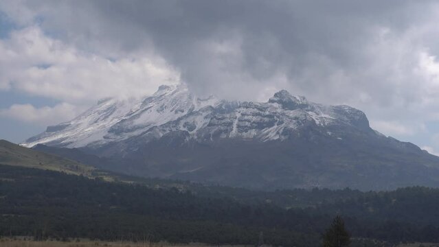 Top of Iztaccihuatl volcano covered with snow.